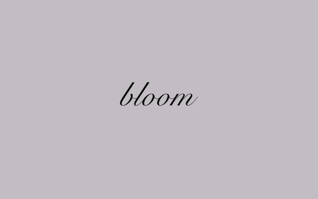Small text tattoo design reading "bloom"